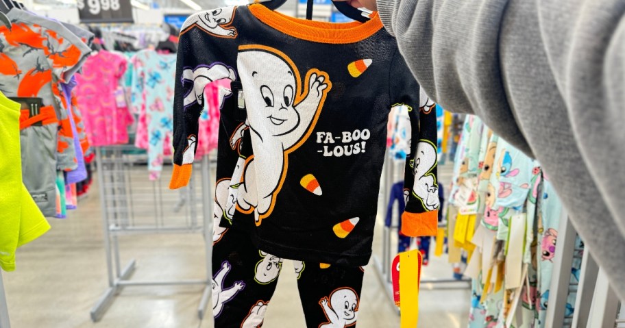 hand holding a set of kid's Casper Halloween pajamas in Walmart