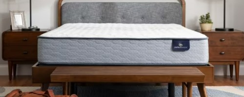 a mattress on a wood platform bed in a bedroom