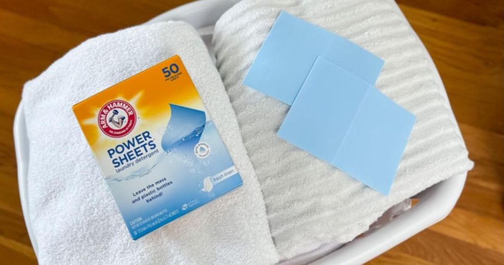 Arm & Hammer Power Sheets Laundry Detergent, Fresh Linen 50ct on basket of towels