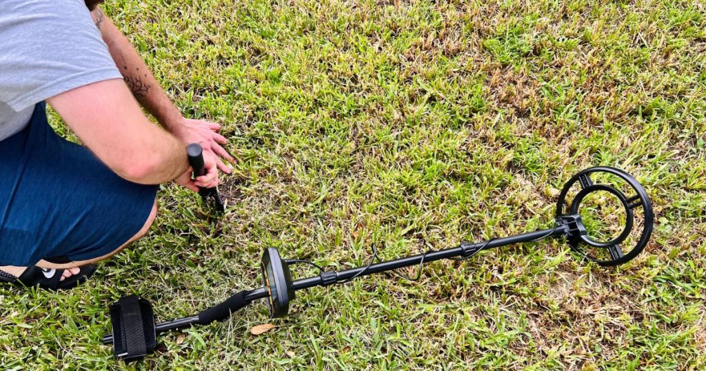 Man digging in the yard after using a ULHUND Metal Detector 