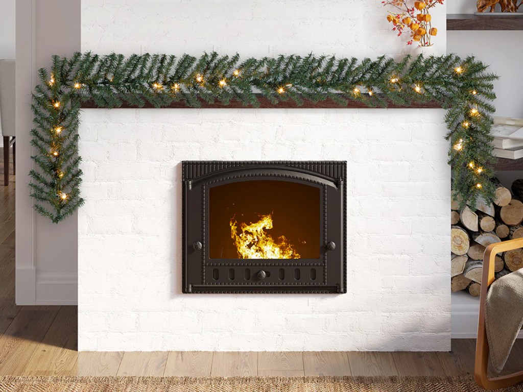 green lighted garland on fireplace mantel
