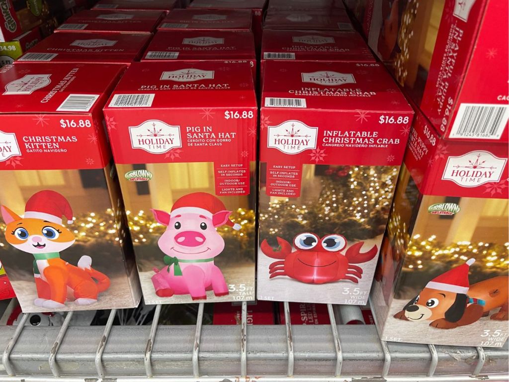 4 boxes of Holiday Time inflatables on the shelf at Walmart