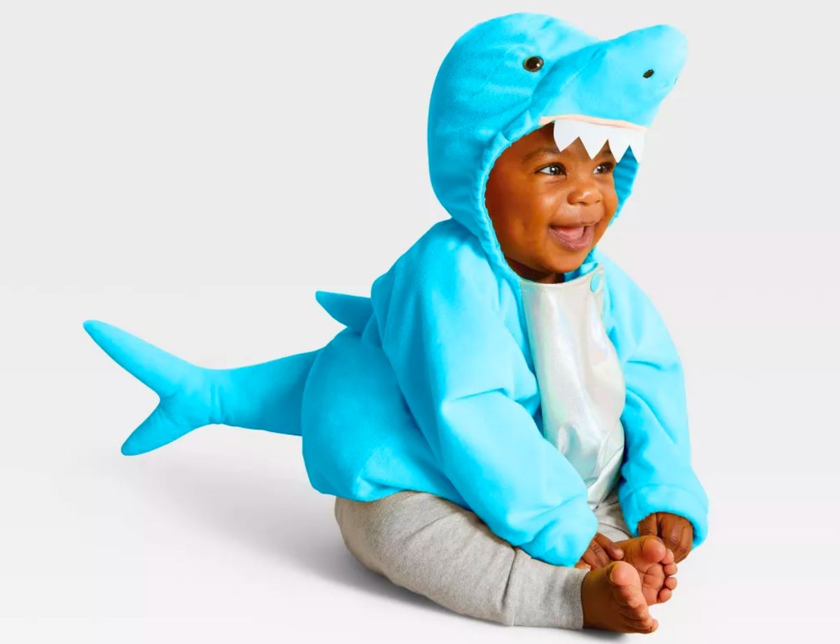 a baby seated on the floor wearing a Hyde &amp; EEK! Baby Shark Halloween Costume Pullover Top