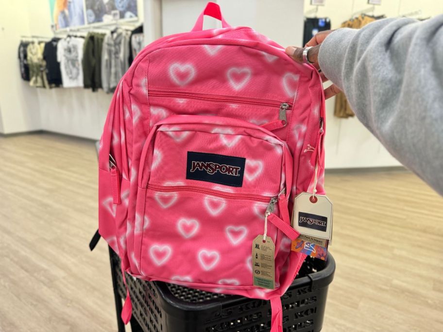 JanSport Big Student Backpack in Happy Hearts Pink in hand in cart