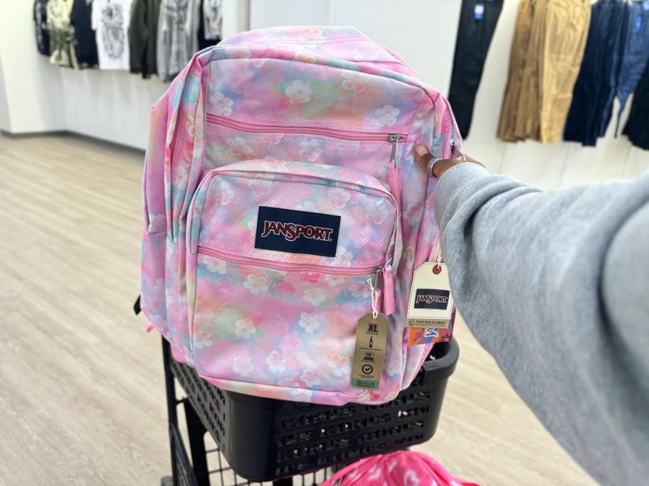 JanSport Big Student Backpack in Neon Daisy in hand in cart