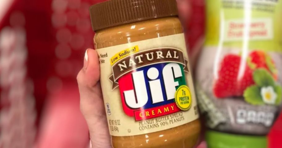 hand holding a jar of Jif natural honey peanut butter