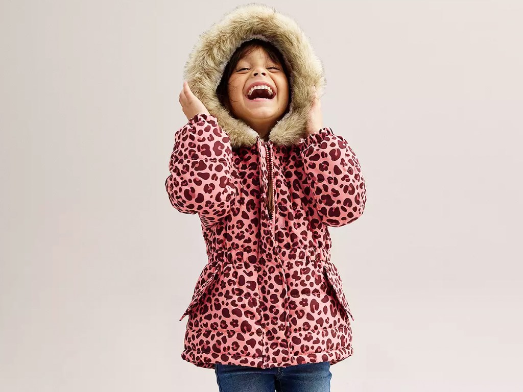 girl in a pink leopard print jacket with fur-lined hood