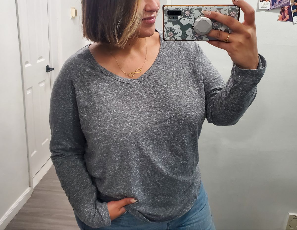 a woman taking a selfie wearing a Juniors' Plus Size SO Long Sleeve V-neck Tee
