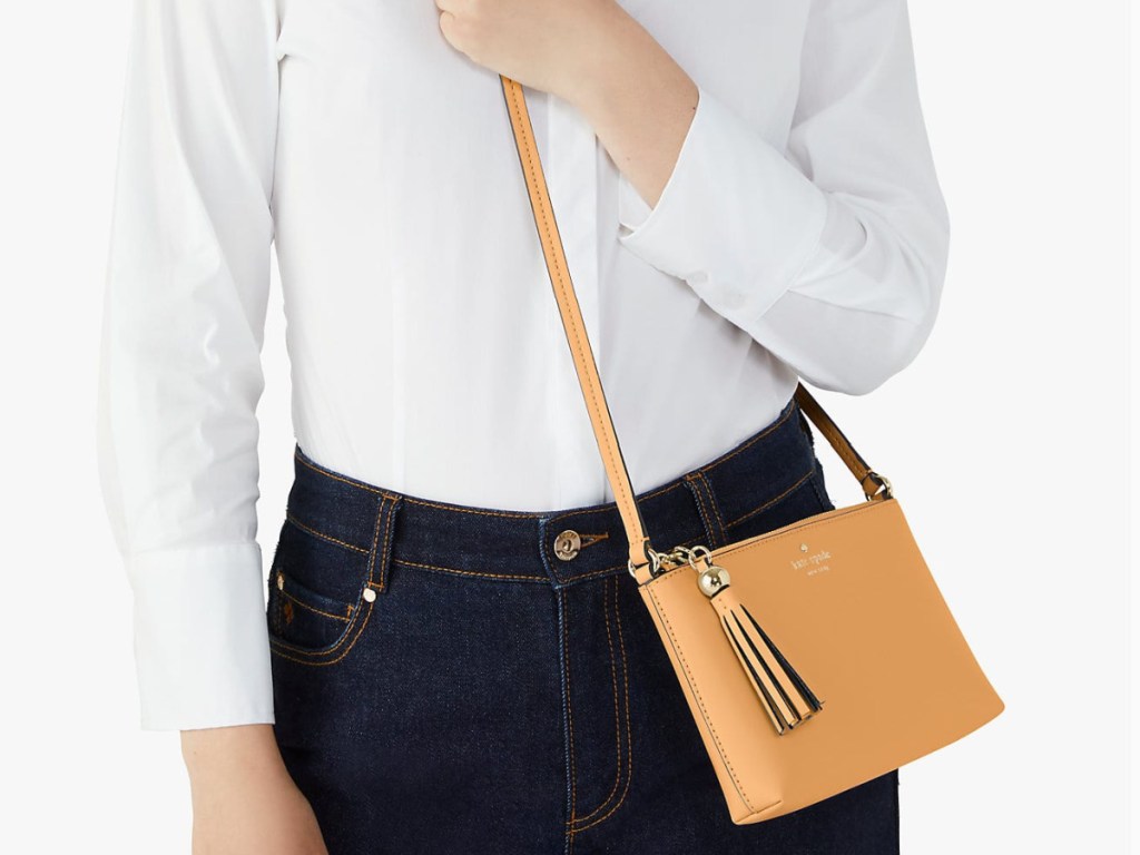 Kate Spade Ivy Street Amy Crossbody on woman wearing a white blouse and black pants