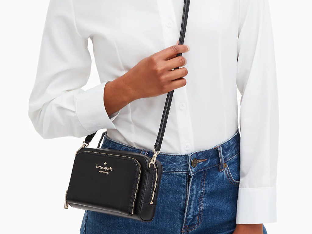 woman in white top and jeans with black crossbody bag