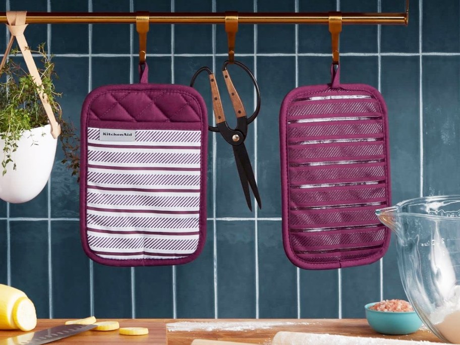 purple striped pot holders hanging in kitchen
