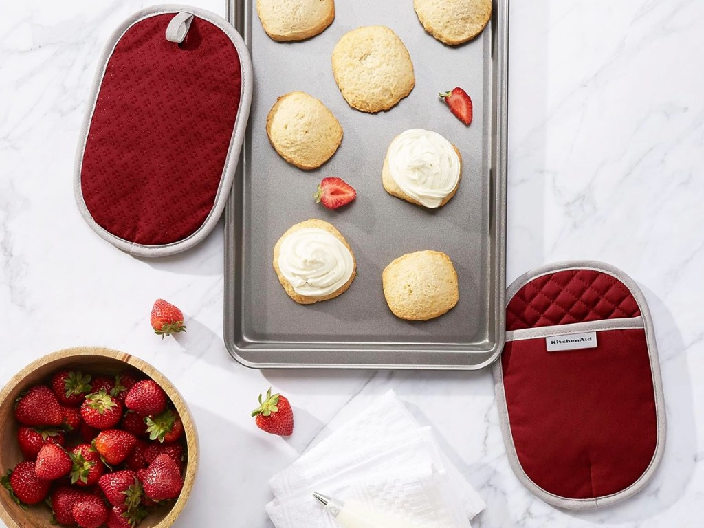 red kitchenaid potholder set near baking sheet of cookies