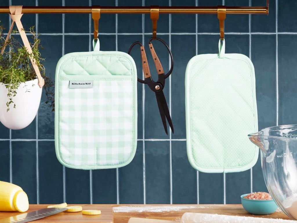 mint green gingham oven mitts hanging in kitchen