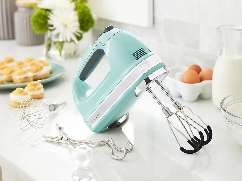 blue kitchenid hand mixer with attachments on kitchen counter