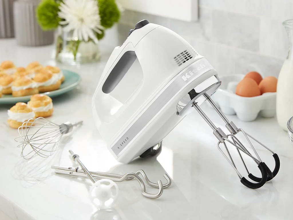 white kitchenid hand mixer with attachments on kitchen counter