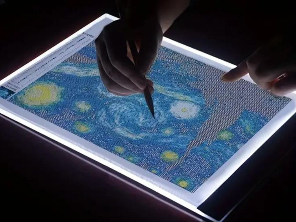 Person using a light up pad for diamond painting