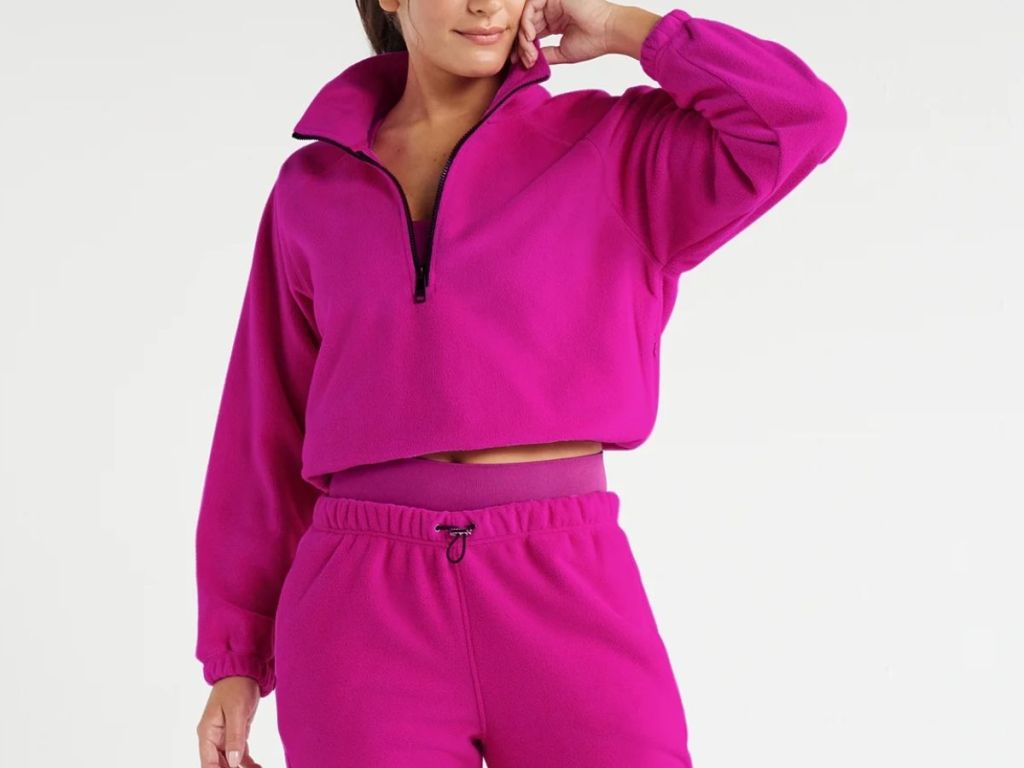 woman wearing Love & Sports quarter zip pullover in hot pink