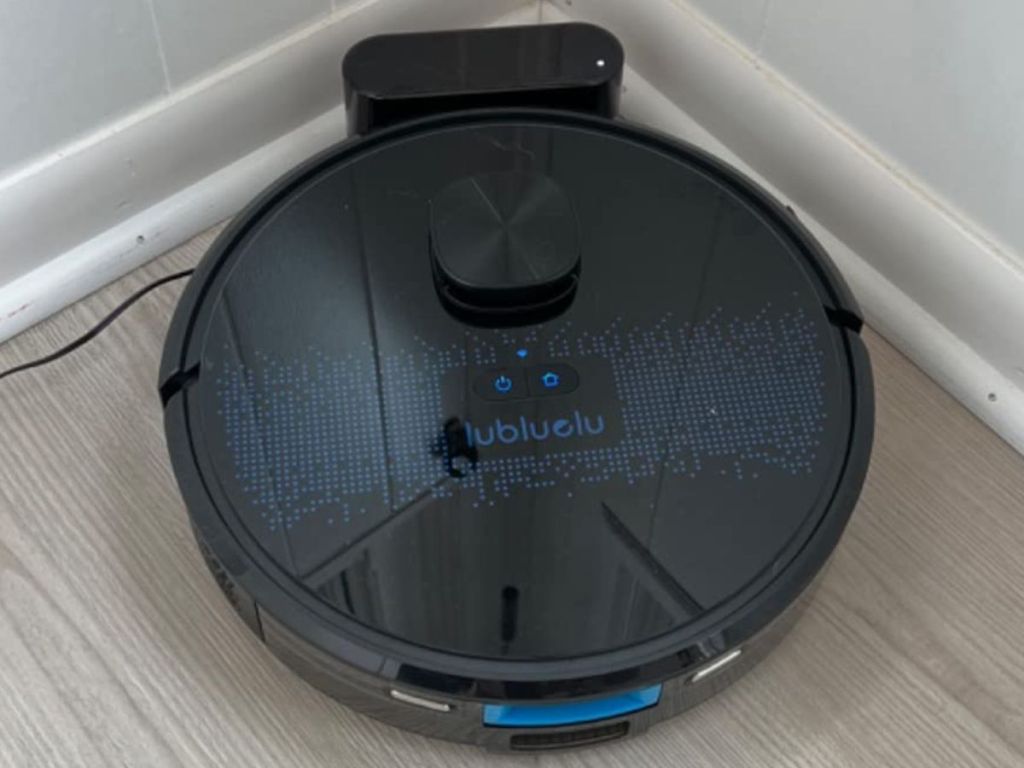 Lubluelu 2 in 1 Robotic Vacuum Cleaner on its charger in a corner of a room