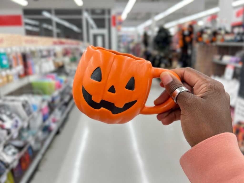 A hand holding Michael's Mug Pumpkin