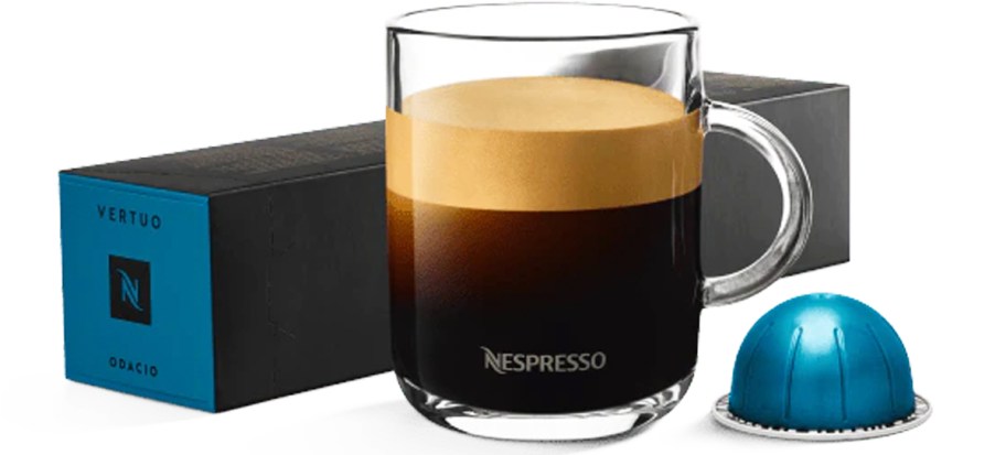 cup of coffee with nespresso pod and box of pods behind it