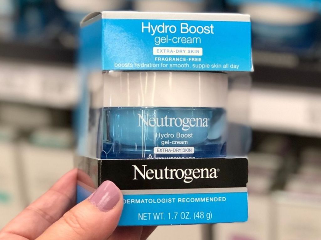 Hand holding up a package of Neutrogena Hydro Boost Moisturizer