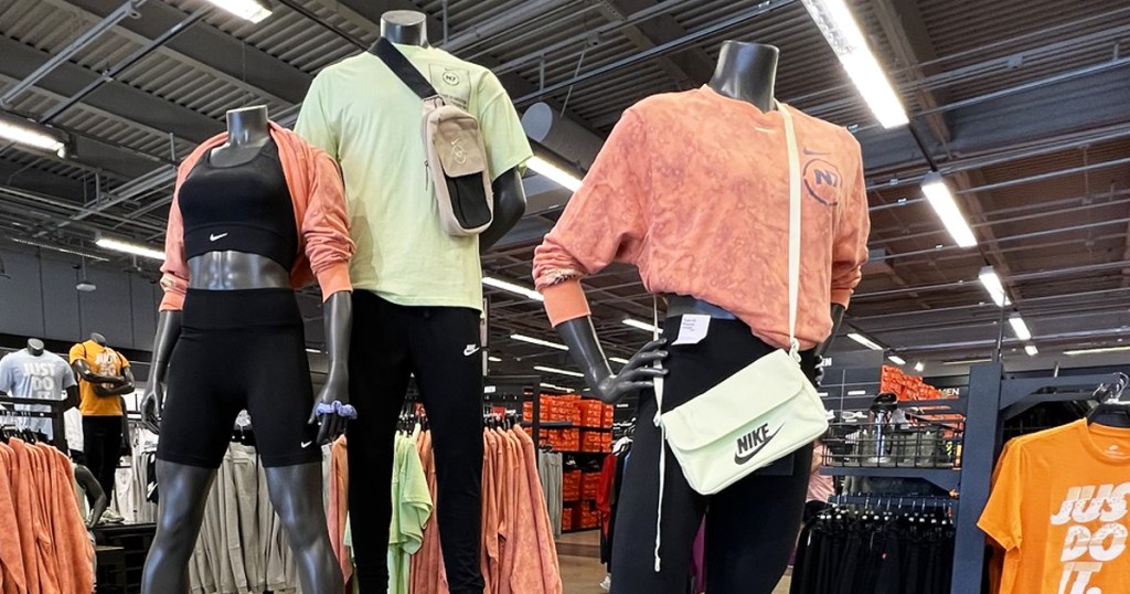 mannequins in nike gear with crossbody bags