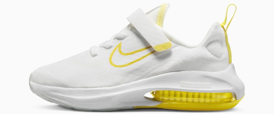 white and yellow nike running shoe