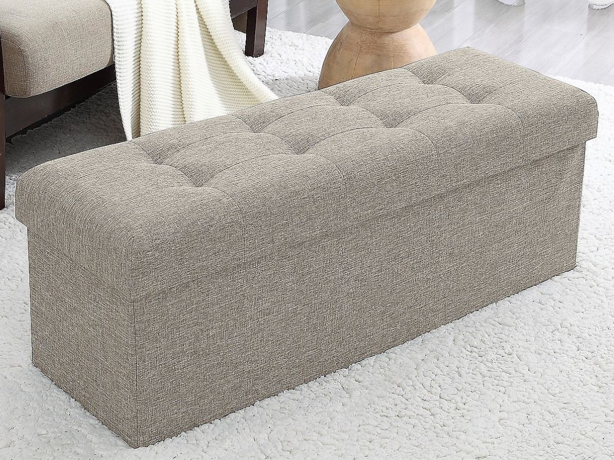 tan colored foldable storage ottoman with tufted top