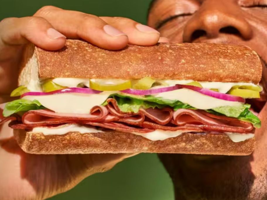 A man eating a Panera Sandwich