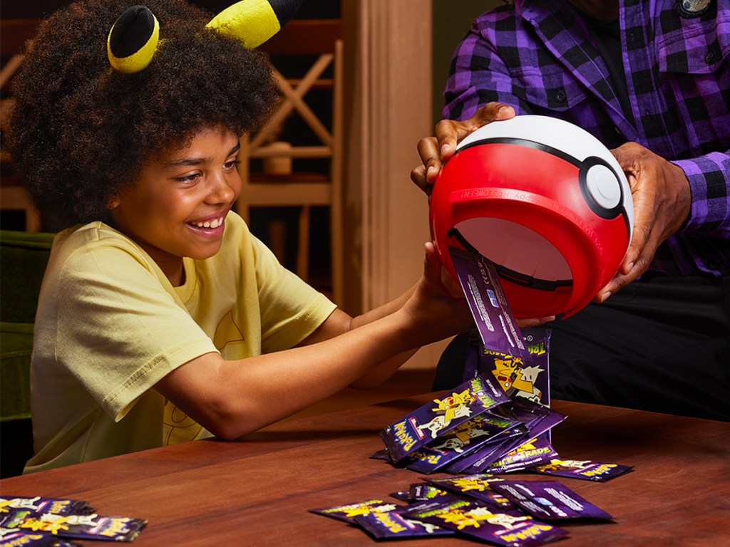 kid dumping pokemon halloween cards from candy bucket