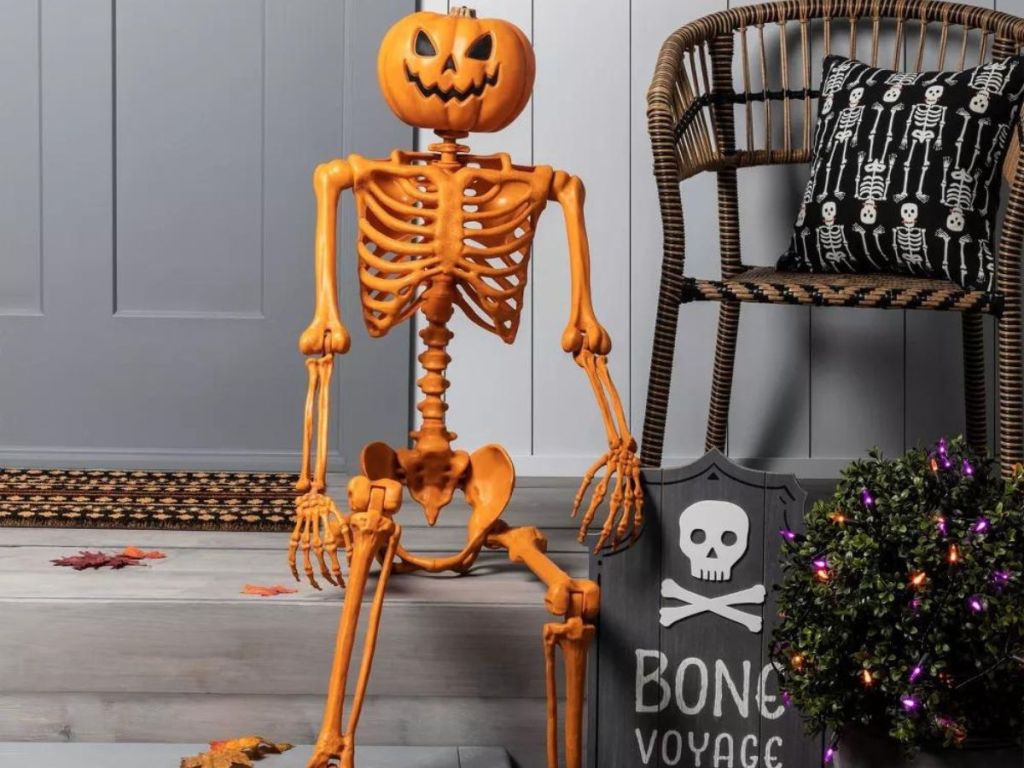 Posable Pumpkin Skeleton Halloween sitting on front stoop