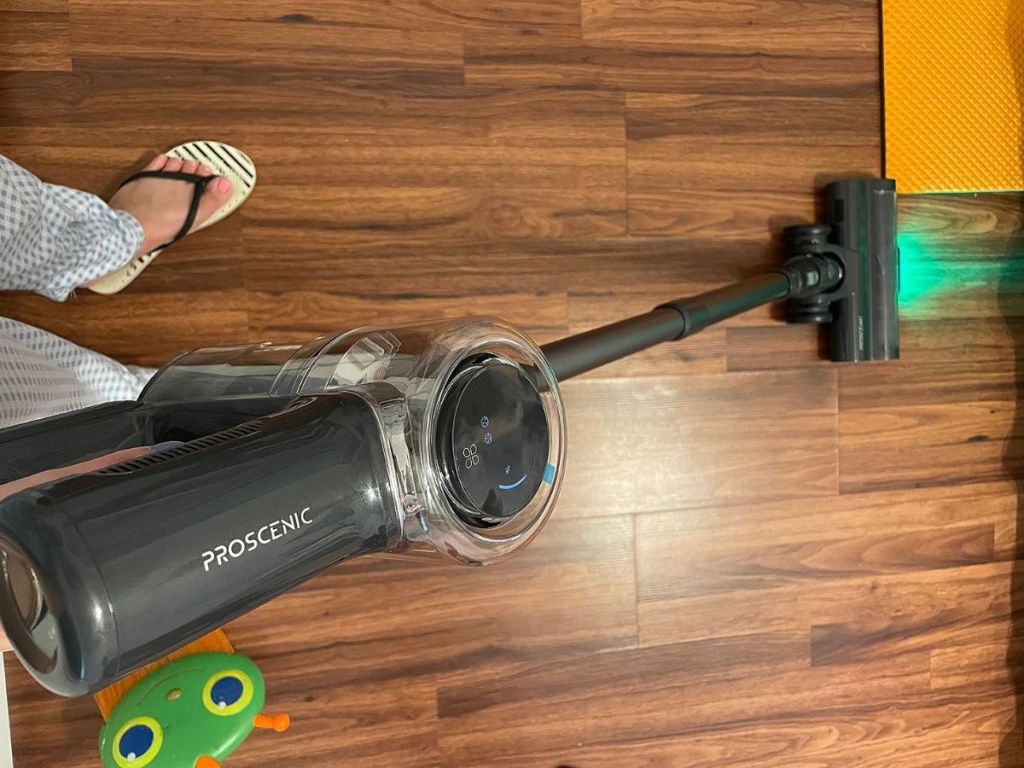person using Cordless Vacuum Cleaner on wood floor