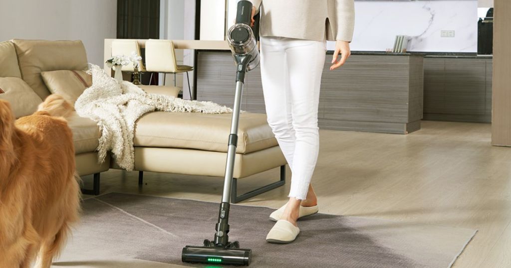 woman using Cordless Vacuum Cleaner on area carpet