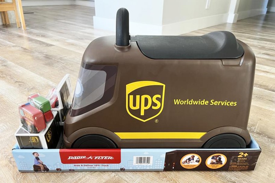 brown Radio Flyer UPS Truck ride-on on wood floor