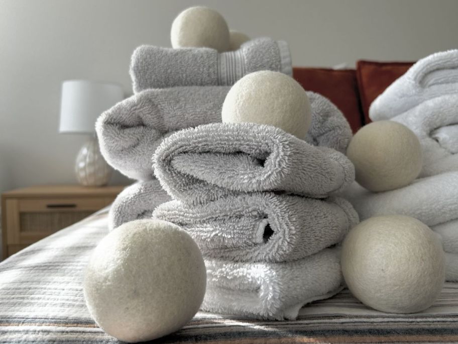 A pile of towels with smart wool dryer balls