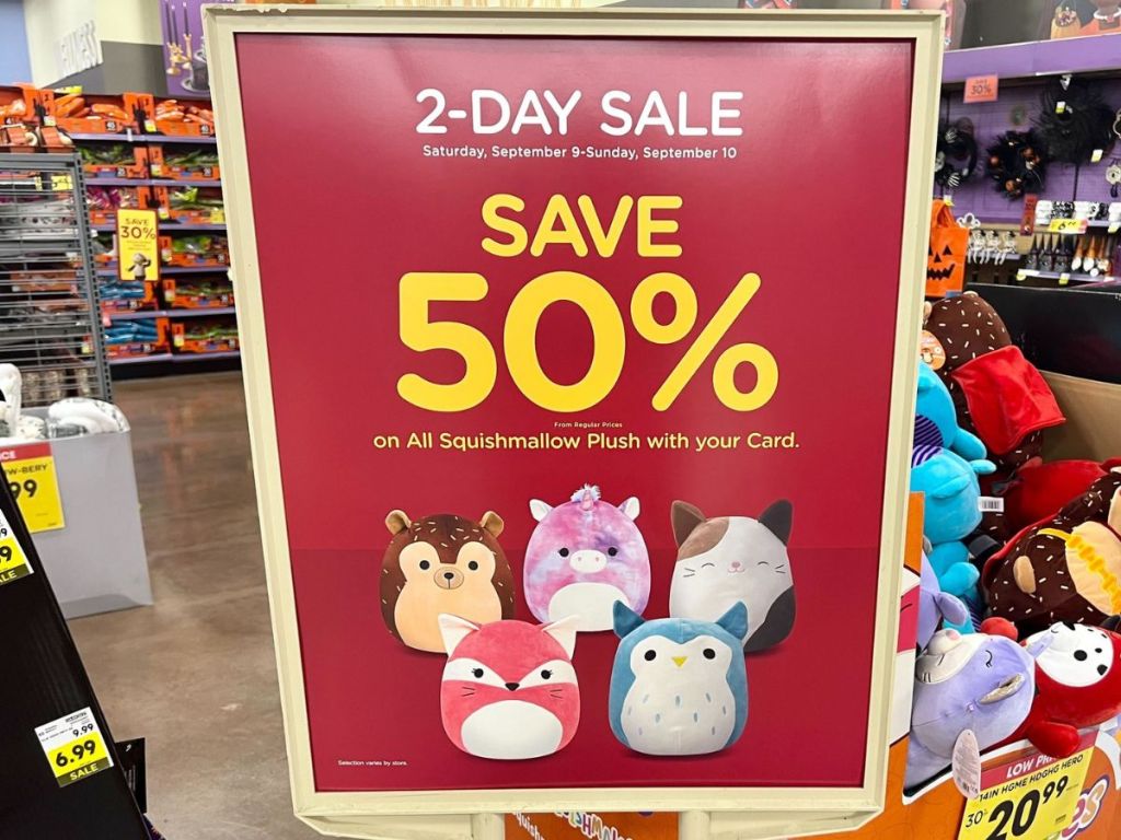 A sign showing a a day sale for 50% off Squishmallows at Kroger