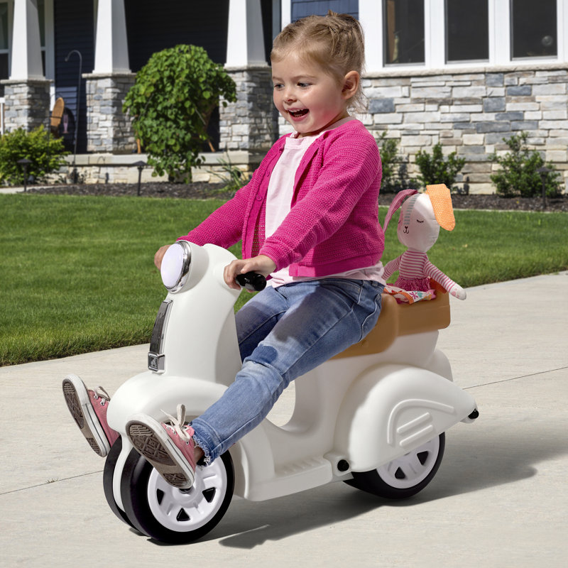 little girl riding a step2 scooter