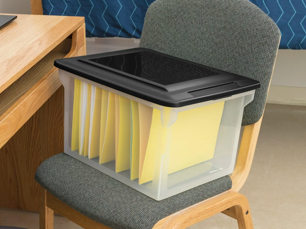 Sterilite Plastic Storage Bin/File Box with files inside on chair