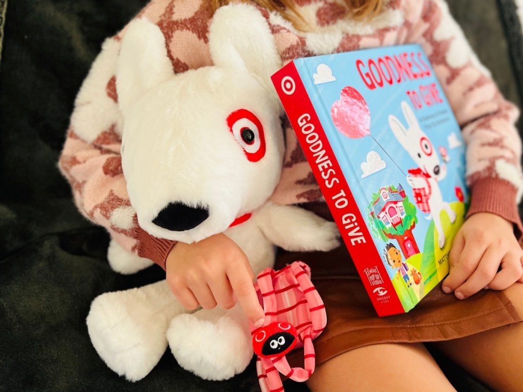 girl holding Target Bullseye Plush with book
