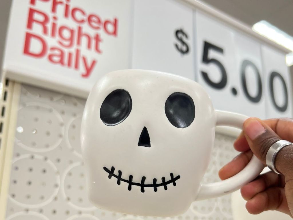 Hand holding a Skull Hallowen mug at Target