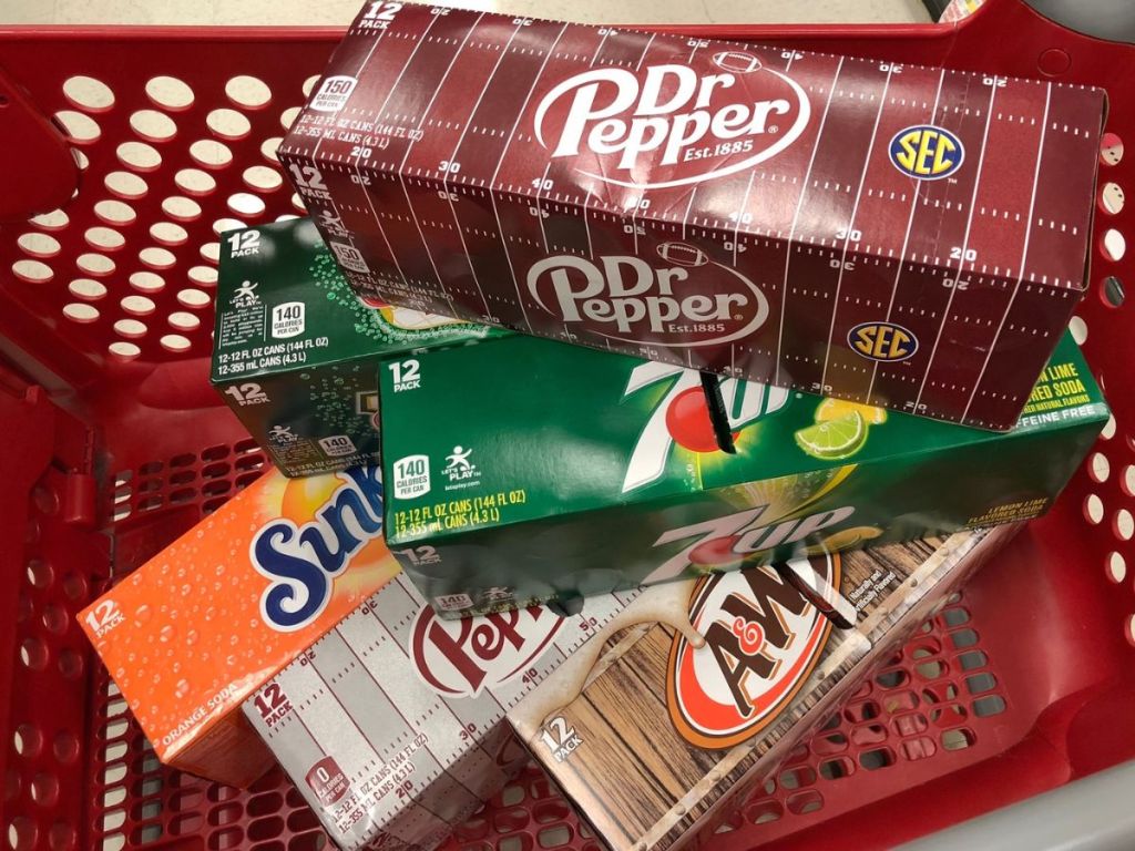A shopping cart of Dr. Pepper, A&W, Sunkist and 7UP Soda 12-packs