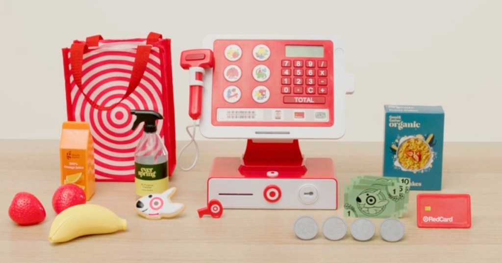Target Toy Cash Register with shopping bag and accessories on tabletop