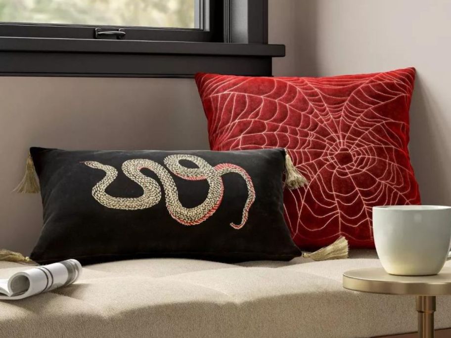 spiderweb and snake pillows on couch