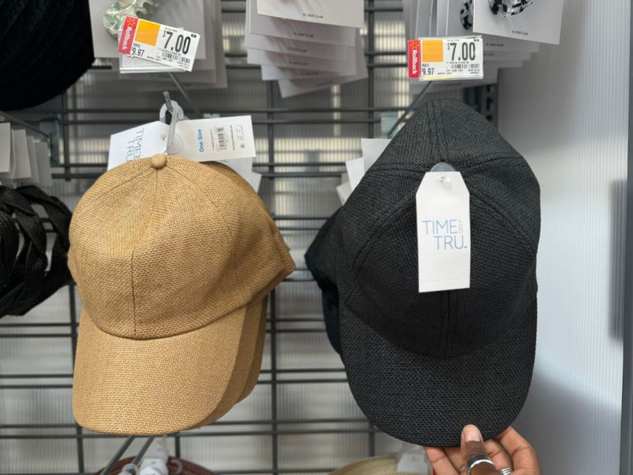 a natural colored and black woven baseball caps