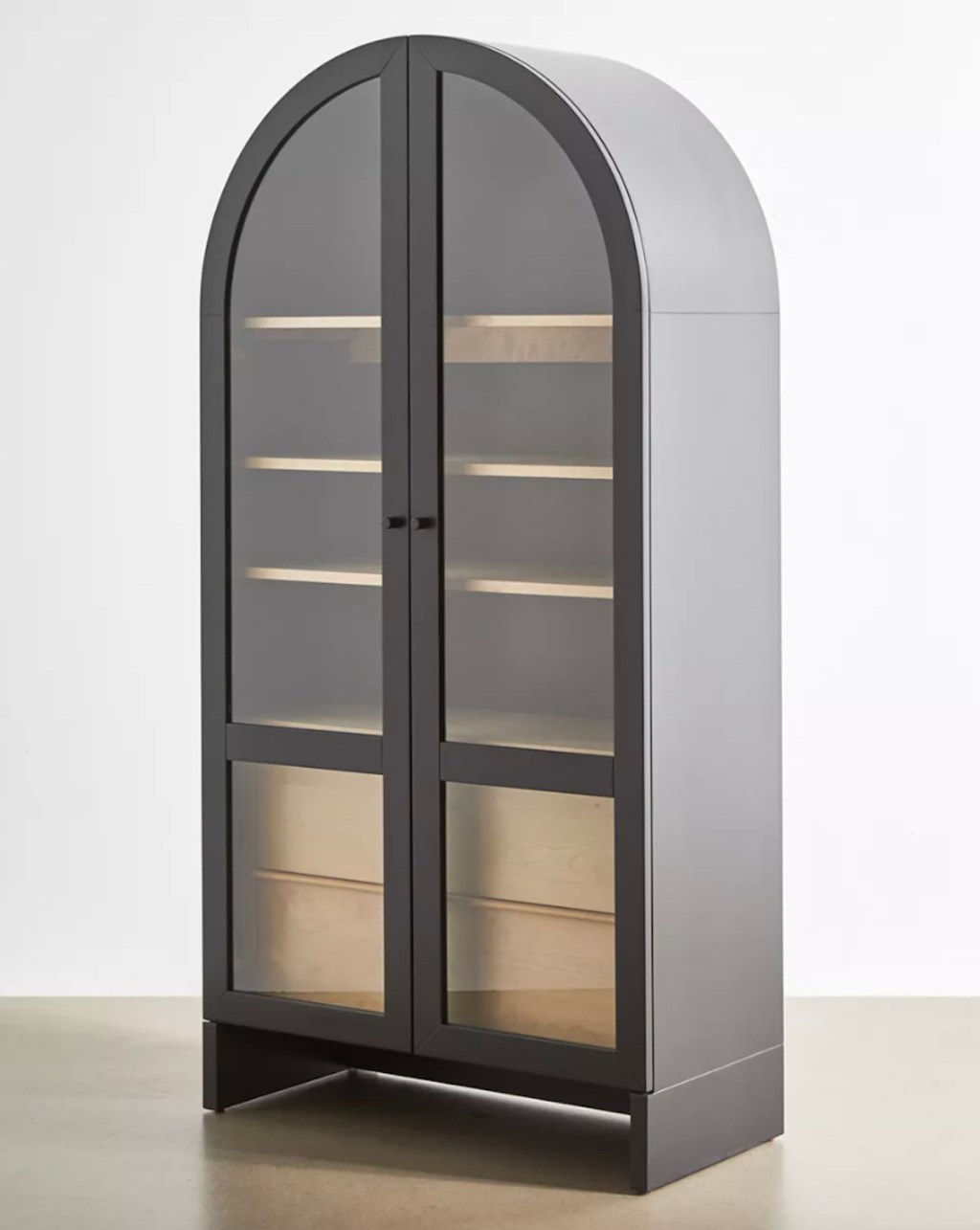black arch wood cabinet sitting on wood floor