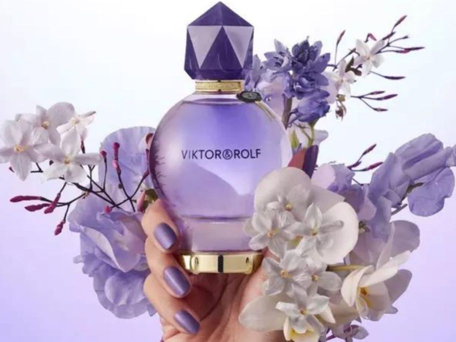 Hand holding a bottle of Viktor&Rolf Good Fortune Perfume