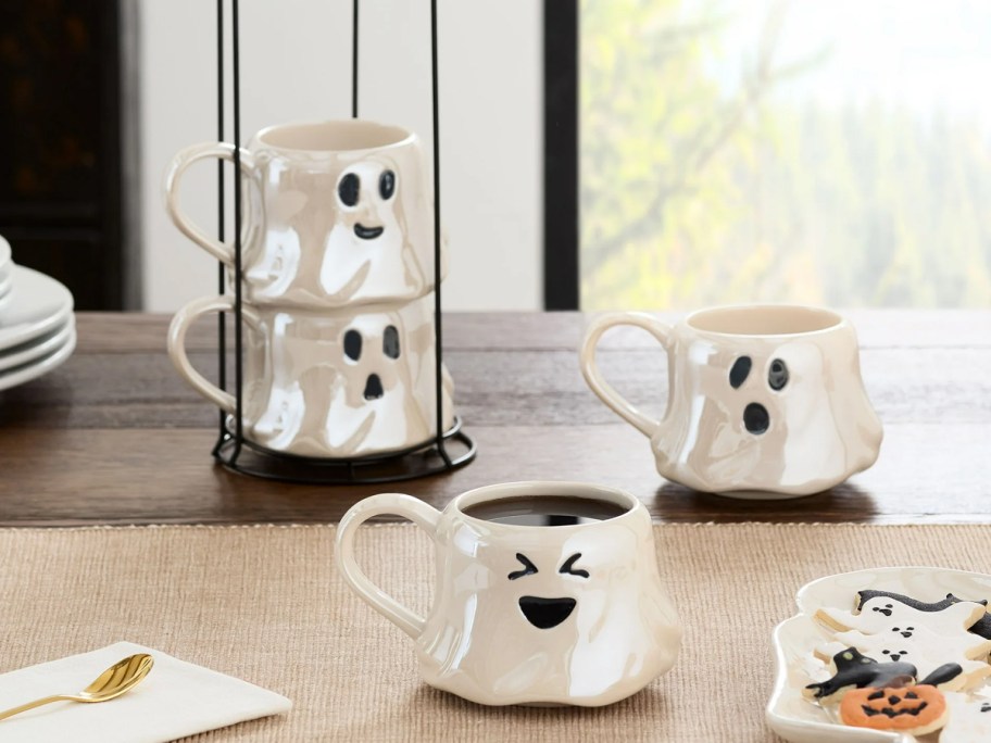 set of 4 iridescent ghost mugs on table