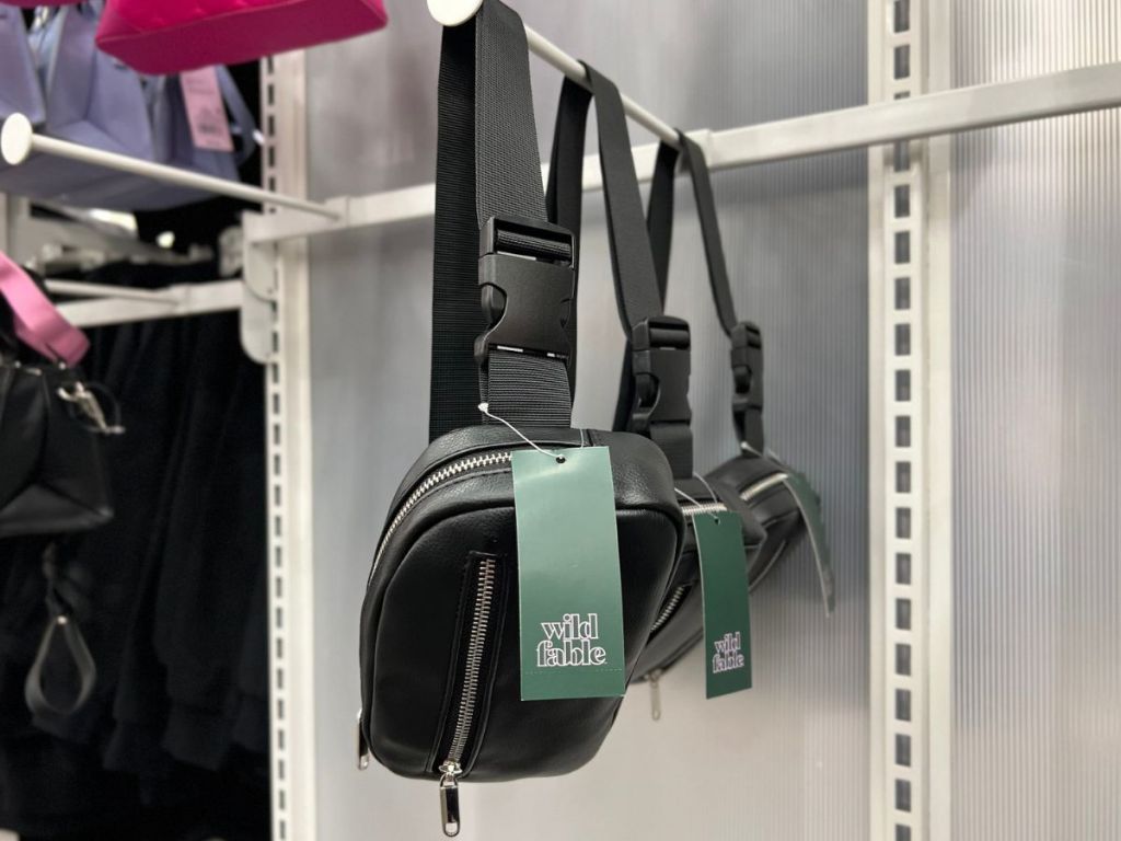 Faux black leather Wild Fable Belt bags hanging on a rack at Target