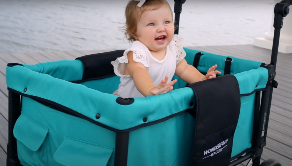 A baby enjoying a WonderFold Wagon Double Stroller Wagon