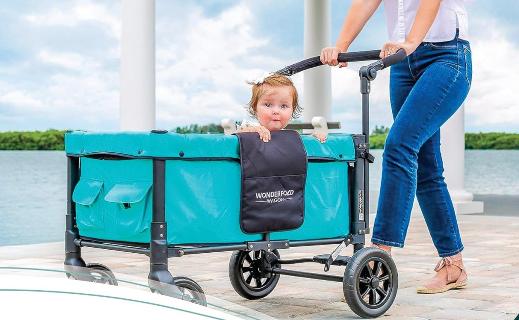 A woman pushing a Wagonfold Double Stroller Wagon